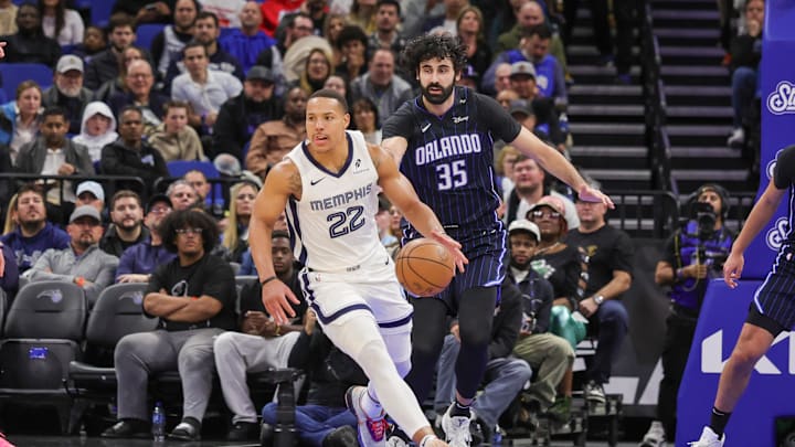 Feb 21, 2025; Orlando, Florida, USA; Memphis Grizzlies guard Desmond Bane (22) moves the ball in front of Orlando Magic center Goga Bitadze (35) during the second quarter at Kia Center. Mandatory Credit: Mike Watters-Imagn Images Feb 21, 2025; Orlando, Florida, USA; Memphis Grizzlies guard Desmond Bane (22) moves the ball in front of Orlando Magic center Goga Bitadze (35) during the second quarter at Kia Center. Mandatory Credit: Mike Watters-Imagn Images