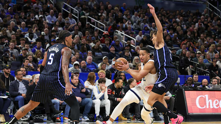 Feb 21, 2025; Orlando, Florida, USA; Memphis Grizzlies guard Desmond Bane (22) drives past Orlando Magic forward Tristan da Silva (23) during the second half at Kia Center. Mandatory Credit: Mike Watters-Imagn Images
