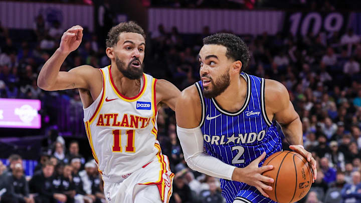 Oct 24, 2025; Orlando, Florida, USA; Orlando Magic guard Tyus Jones (2) drives to the basket against Atlanta Hawks guard Trae Young (11) during the second half at Kia Center. Mandatory Credit: Mike Watters-Imagn Images