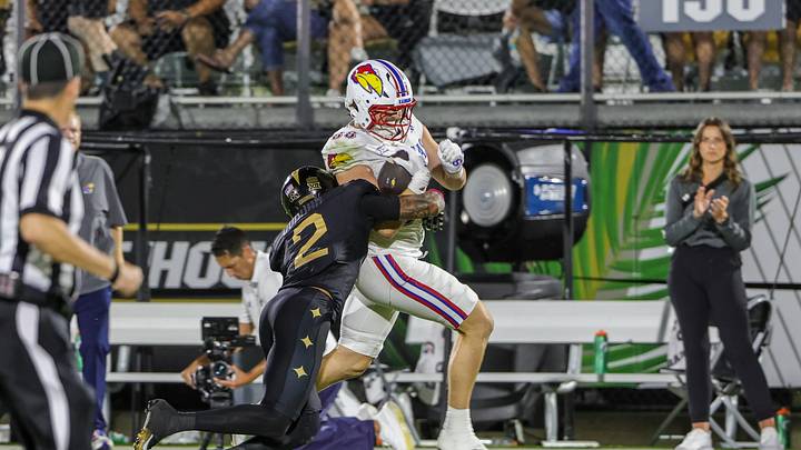 Oct 4, 2025; Orlando, Florida, USA; Kansas Jayhawks tight end Boden Groen (88) is tackled by UCF Knights defensive back Phillip Dunnam (2) during the second quarter at FBC Mortgage Stadium. Mandatory Credit: Mike Watters-Imagn Images Oct 4, 2025; Orlando, Florida, USA; Kansas Jayhawks tight end Boden Groen (88) is tackled by UCF Knights defensive back Phillip Dunnam (2) during the second quarter at FBC Mortgage Stadium. Mandatory Credit: Mike Watters-Imagn Images