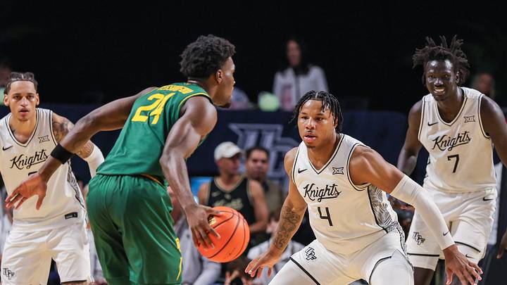 Feb 28, 2026; Orlando, Florida, USA; UCF Knights forward Jamichael Stillwell (4) defends Baylor Bears guard Tounde Yessoufou (24) during the first half at Addition Financial Arena. Mandatory Credit: Mike Watters-Imagn Images Feb 28, 2026; Orlando, Florida, USA; UCF Knights forward Jamichael Stillwell (4) defends Baylor Bears guard Tounde Yessoufou (24) during the first half at Addition Financial Arena. Mandatory Credit: Mike Watters-Imagn Images