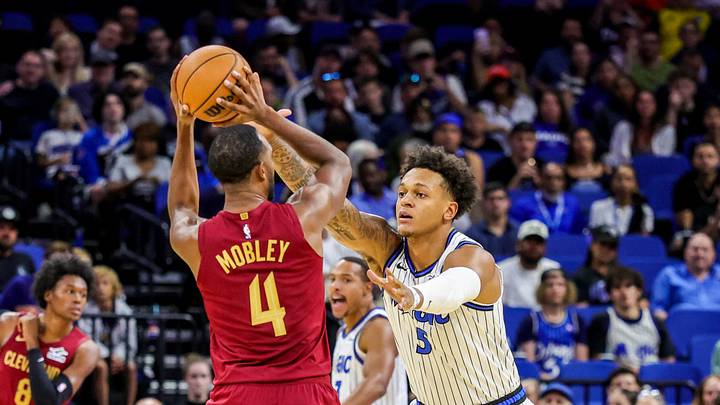 Oct 13, 2026; Orlando, Florida, USA;  Orlando Magic forward Paolo Banchero (5) defends Cleveland Cavaliers forward Evan Mobley (4) during the first quarter at Kia Center.  Mandatory Credit: Mike Watters-Imagn Images