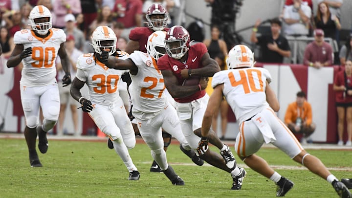 Oct 21, 2023; Tuscaloosa, Alabama, USA;  Tennessee Volunteers defensive lineman James Pearce Jr. (27) and Tennessee Volunteers linebacker Kalib Perry (40) close in to tackle Alabama Crimson Tide quarterback Jalen Milroe (4) at Bryant-Denny Stadium. Alabama defeated Tennessee 34-20. Mandatory Credit: Gary Cosby Jr.-Imagn Images