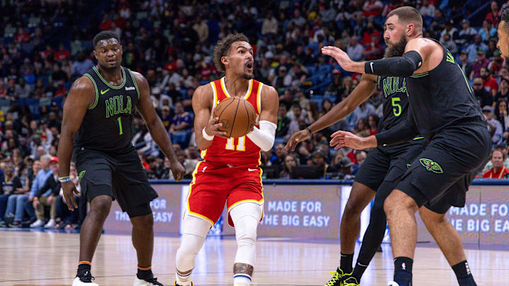 Nov 4, 2023; New Orleans, Louisiana, USA;  Atlanta Hawks guard Trae Young (11) brings the ball up court around New Orleans Pelicans forward Zion Williamson (1) and forward Herbert Jones (5) during the first half at Smoothie King Center. Mandatory Credit: Stephen Lew-USA TODAY Sports