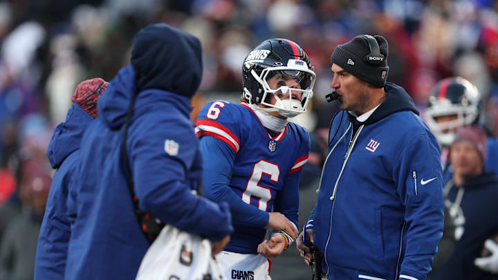 Dec 14, 2025; East Rutherford, New Jersey, USA;  New York Giants quarterback Jaxson Dart (6) talks with interim head coach Mike Kafka during the fourth quarter against the Washington Commanders at MetLife Stadium.  