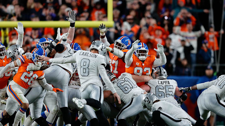 Nov 6, 2025; Denver, Colorado, USA; Las Vegas Raiders place kicker Daniel Carlson (8) misses a field goal as Denver Broncos defensive tackle D.J. Jones (93) and wide receiver A.T. Perry (87) defend in the fourth quarter at Empower Field at Mile High. Mandatory Credit: Isaiah J. Downing-Imagn Images