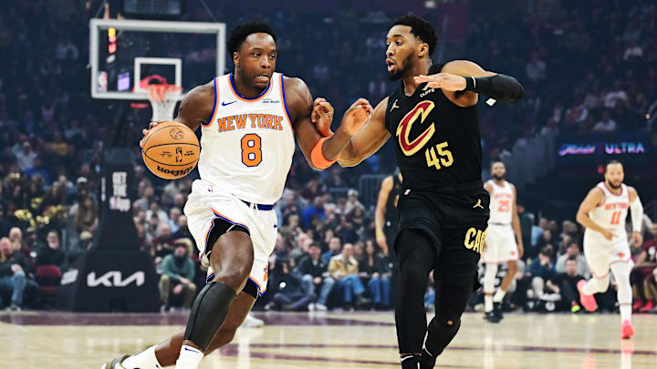 Feb 21, 2025; Cleveland, Ohio, USA;  New York Knicks forward OG Anunoby (8) drives to the basket against Cleveland Cavaliers guard Donovan Mitchell (45) during the first half at Rocket Arena. Mandatory Credit: Ken Blaze-Imagn Images