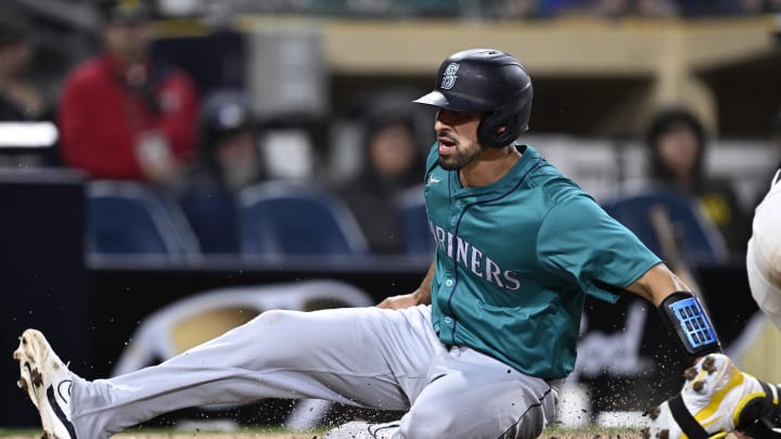 Seattle Mariners catcher Seby Zavala (left) scores a run ahead of the throw to San Diego Padres catcher Brett Sullivan (right) during the ninth inning at Petco Park in spring training. Seattle Mariners catcher Seby Zavala (left) scores a run ahead of the throw to San Diego Padres catcher Brett Sullivan (right) during the ninth inning at Petco Park in spring training.