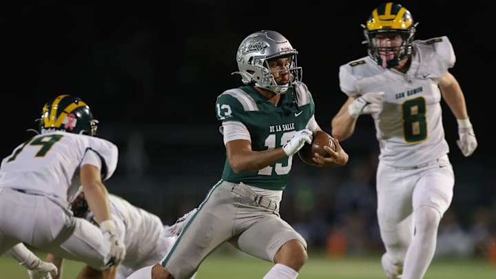 De La Salle QB Toa Faavae jukes a couple defenders on his way to a 12-yard scamper in Friday's 42-14 win over San Ramon Valley.