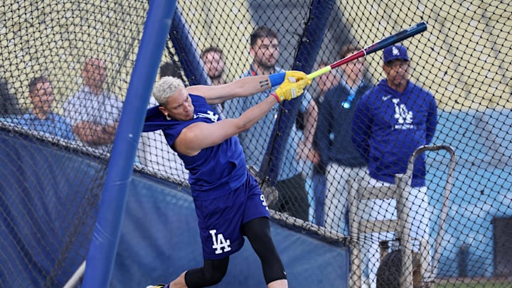 Oct 12, 2024; Los Angeles, California, USA; Los Angeles Dodgers shortstop Miguel Rojas (11) takes a batting practice during workouts before the start of the NLCS against the New York Mets at Dodgers Stadium.