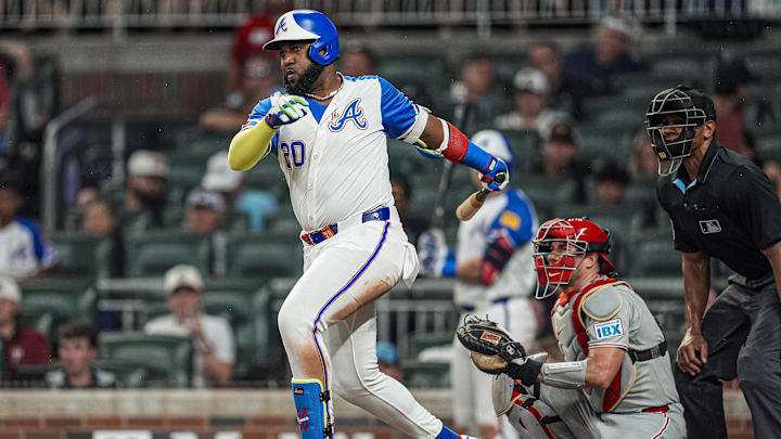 Jun 28, 2025; Cumberland, Georgia, USA; Atlanta Braves designated hitter Marcell Ozuna (20) singles against the Philadelphia Phillies during the seventh inning at Truist Park. Mandatory Credit: Dale Zanine-Imagn Images