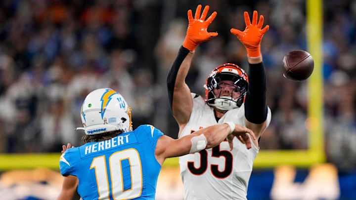 Cincinnati Bengals linebacker Logan Wilson (55) rushes Los Angeles Chargers quarterback Justin Herbert (10) as he throws a pass in the third quarter of the NFL Week 11 game between the Los Angeles Chargers and the Cincinnati Bengals at SoFi Stadium in Inglewood, Calif., on Sunday, Nov. 17, 2024. The Chargers won 34-27.