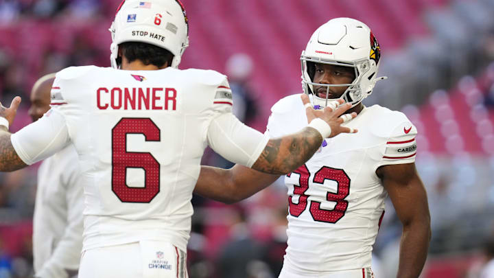 Arizona Cardinals running backs James Conner (6) and Trey Benson (33) high-five before they play against the New England Patriots at State Farm Stadium on Dec. 15, 2024.
