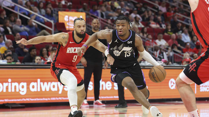Apr 2, 2025; Houston, Texas, USA; Utah Jazz guard Isaiah Collier (13) drives with the ball as Houston Rockets forward Dillon Brooks (9) defends during the second quarter at Toyota Center. Mandatory Credit: Troy Taormina-Imagn Images