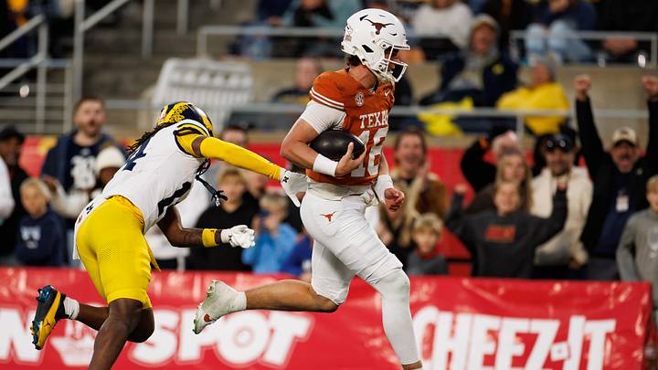 Dec 31, 2025; Orlando, FL, USA; Texas Longhorns quarterback Arch Manning (16) rushes with the ball past Michigan Wolverines defensive back Jordan Young (14) for a touchdown during the second half at Camping World Stadium. Mandatory Credit: Matt Pendleton-Imagn Images Dec 31, 2025; Orlando, FL, USA; Texas Longhorns quarterback Arch Manning (16) rushes with the ball past Michigan Wolverines defensive back Jordan Young (14) for a touchdown during the second half at Camping World Stadium. Mandatory Credit: Matt Pendleton-Imagn Images