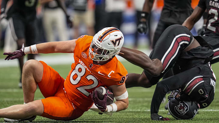 Aug 31, 2025; Atlanta, Georgia, USA; South Carolina Gamecocks linebacker Fred Johnson (0) tackles Virginia Tech Hokies tight end Benji Gosnell (82) during the first half at Mercedes-Benz Stadium. Mandatory Credit: Dale Zanine-Imagn Images Aug 31, 2025; Atlanta, Georgia, USA; South Carolina Gamecocks linebacker Fred Johnson (0) tackles Virginia Tech Hokies tight end Benji Gosnell (82) during the first half at Mercedes-Benz Stadium. Mandatory Credit: Dale Zanine-Imagn Images