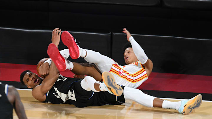 Dec 14, 2024; Las Vegas, Nevada, USA; Atlanta Hawks forward Jalen Johnson (1) and Milwaukee Bucks forward Giannis Antetokounmpo (34) battle for a loose ball during the fourth quarter in a semifinal of the 2024 Emirates NBA Cup at T-Mobile Arena. Mandatory Credit: Candice Ward-Imagn Images