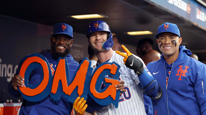 New York Mets first baseman Pete Alonso (20) celebrates in the dugout after hitting a solo home run with New York Mets pitcher Luis Severino (left) and pitcher Jose Quintana (right) in the second inning against the Philadelphia Phillies during game three of the NLDS for the 2024 MLB Playoffs at Citi Field. 
