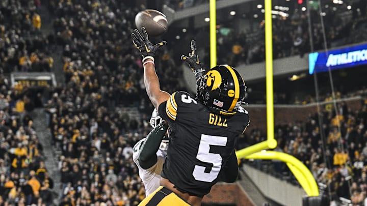 Nov 22, 2025; Iowa City, Iowa, USA; Iowa Hawkeyes wide receiver Jacob Gill (5) catches the game tying touchdown as Michigan State Spartans defensive back Dontavius Nash (28) defends during the fourth quarter at Kinnick Stadium. Mandatory Credit: Jeffrey Becker-Imagn Images
