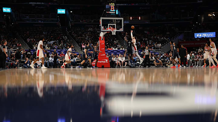 Apr 3, 2025; Washington, District of Columbia, USA; Washington Wizards forward Tristan Vukcevic (00) shoots the ball as Orlando Magic forward Jonathan Isaac (1) defends in the first half at Capital One Arena. Mandatory Credit: Geoff Burke-Imagn Images