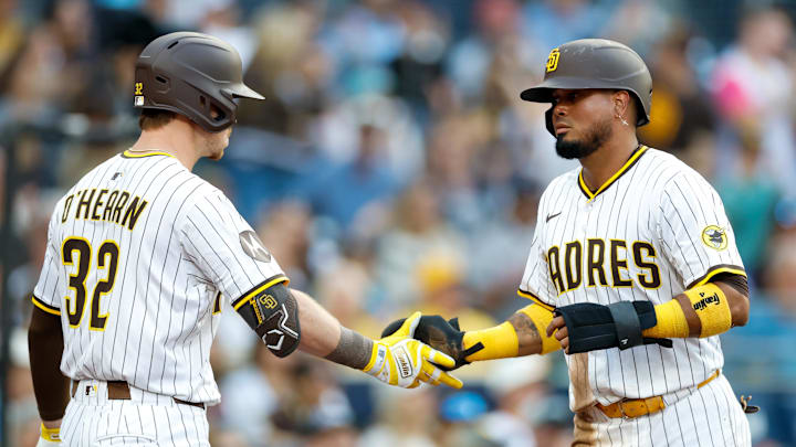 Sep 13, 2025; San Diego, California, USA; San Diego Padres second baseman Luis Arraez (4) first baseman Ryan O'Hearn (32) after scoring a run during the first inning against the Colorado Rockies at Petco Park. Mandatory Credit: David Frerker-Imagn Images