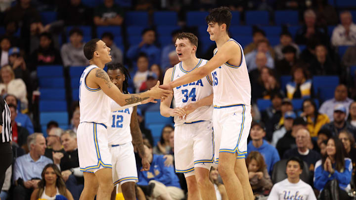 Jan 21, 2025; Los Angeles, California, USA;  UCLA Bruins center Aday Mara (15) is greeted by guard Kobe Johnson (0) during the second half against the Wisconsin Badgers at Pauley Pavilion presented by Wescom. Mandatory Credit: Kiyoshi Mio-Imagn Images