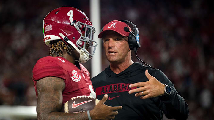 Sep 28, 2024; Tuscaloosa, Alabama, USA; Alabama Crimson Tide quarterback Jalen Milroe (4) and head coach Kalen DeBoer talk during a timeout in the first quarter against the Georgia Bulldogs at Bryant-Denny Stadium. Mandatory Credit: Will McLelland-Imagn Images