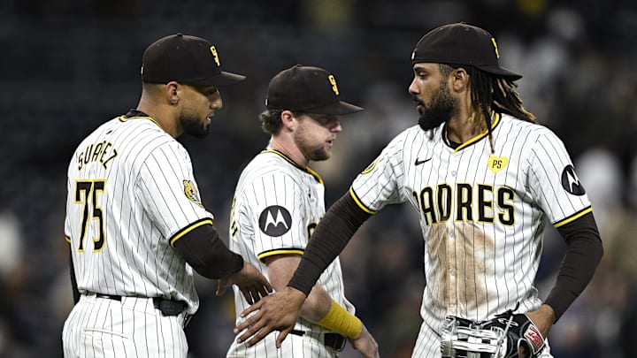 Apr 30, 2024; San Diego, California, USA; San Diego Padres right fielder Fernando Tatis Jr. (right) celebrates on the field with first baseman Jake Cronenworth (9) and relief pitcher Robert Suarez (75) after defeating the Cincinnati Reds at Petco Park. Mandatory Credit: Orlando Ramirez-Imagn Images Apr 30, 2024; San Diego, California, USA; San Diego Padres right fielder Fernando Tatis Jr. (right) celebrates on the field with first baseman Jake Cronenworth (9) and relief pitcher Robert Suarez (75) after defeating the Cincinnati Reds at Petco Park. Mandatory Credit: Orlando Ramirez-Imagn Images