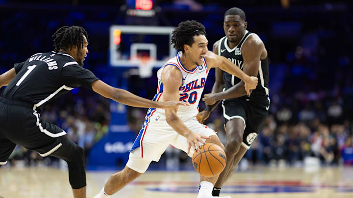 Oct 16, 2024; Philadelphia, Pennsylvania, USA; Philadelphia 76ers guard Jared McCain (20) dribbles between Brooklyn Nets Ziaire Williams (1) and guard Shake Milton (7) during the fourth quarter at Wells Fargo Center. Mandatory Credit: Bill Streicher-Imagn Images