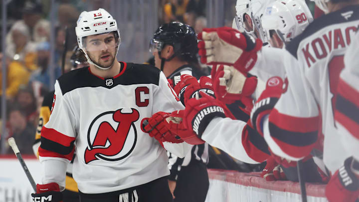 Mar 15, 2025; Pittsburgh, Pennsylvania, USA;  New Jersey Devils center Nico Hischier (13) celebrates with the Devils bench after scoring a goal against the Pittsburgh Penguins during the third period at PPG Paints Arena. Mandatory Credit: Charles LeClaire-Imagn Images