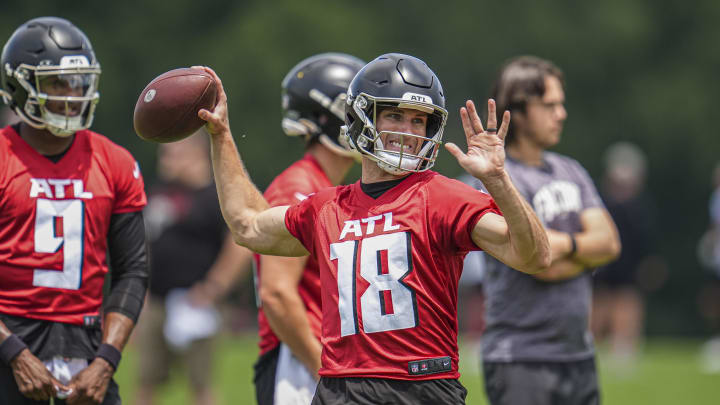 Michael Penix Jr. looks on as Kirk Cousins throws a pass in Atlanta Falcons minicamp.