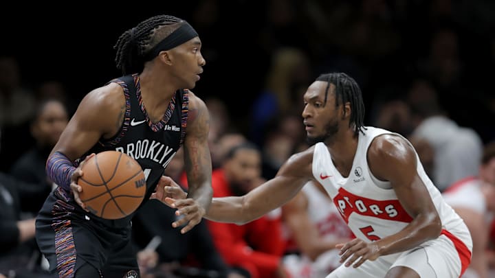 Nov 11, 2025; Brooklyn, New York, USA; Brooklyn Nets guard Terance Mann (14) controls the ball against Toronto Raptors guard Immanuel Quickley (5) during the second quarter at Barclays Center. Mandatory Credit: Brad Penner-Imagn Images
