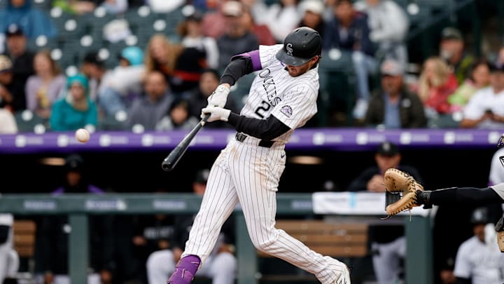 May 25, 2025; Denver, Colorado, USA; Colorado Rockies third baseman Ryan McMahon (24) hits a single in the sixth inning against the New York Yankees at Coors Field. Mandatory Credit: Isaiah J. Downing-Imagn Images