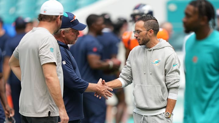 Denver Broncos head coach Sean Peyton, left, and Miami Dolphins head coach Mike McDaniel meet before