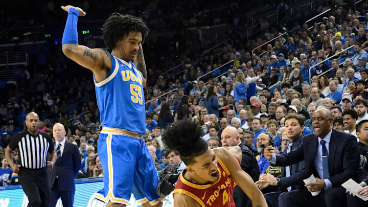 Feb 24, 2026; Los Angeles, California, USA; Southern California Trojans guard Chad Baker-Mazara (4) hits the floor as he tries to drive past UCLA Bruins guard Skyy Clark (55) during the first half at Pauley Pavilion presented by Wescom Financial. Mandatory Credit: Robert Hanashiro-Imagn Images