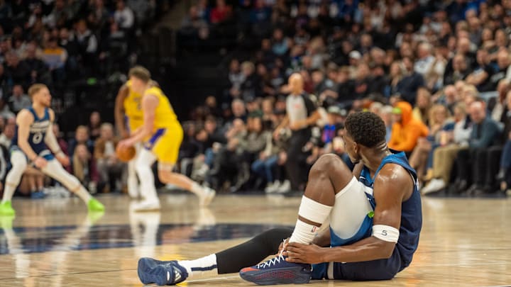 Dec 13, 2024; Minneapolis, Minnesota, USA; Minnesota Timberwolves guard Anthony Edwards (5) rolls his ankle against the Los Angeles Lakers in the third quarter at Target Center. Mandatory Credit: Matt Blewett-Imagn Images