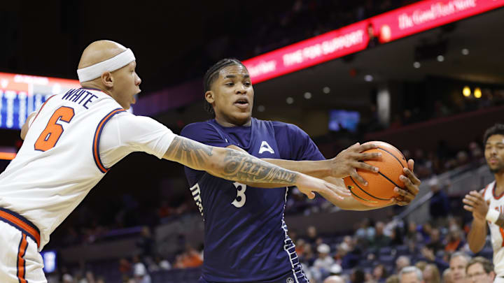 Nov 28, 2025; Charlottesville, Virginia, USA; Queens University of Charlotte Royals guard Isaiah Henry (3) reaches for the ball as Virginia Cavaliers guard Jacari White (6) defends during the second half at John Paul Jones Arena. Mandatory Credit: Amber Searls-Imagn Images
