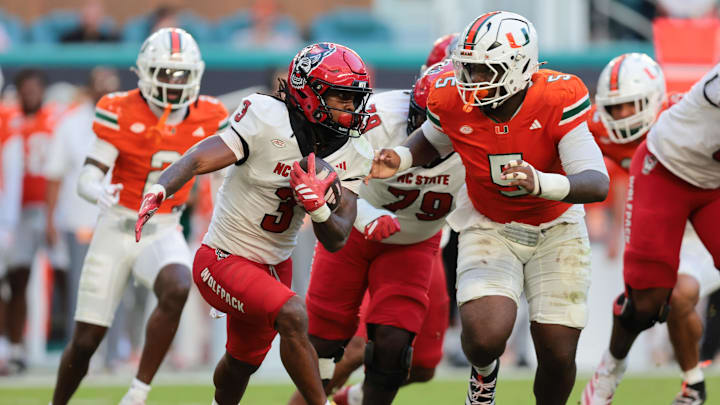 NC State Wolfpack running back Hollywood Smothers (3) carries the football against Miami Hurricanes defensive lineman Justin Scott (5)