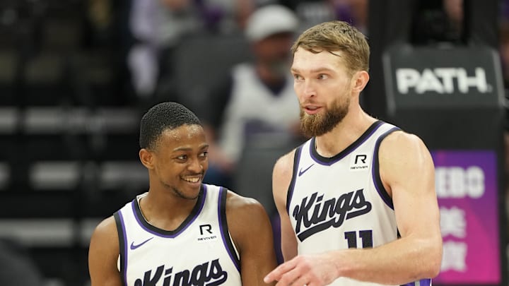 Dec 30, 2024; Sacramento, California, USA; Sacramento Kings guard De'Aaron Fox (5) and forward Domantas Sabonis (right) talk during the third quarter against the Dallas Mavericks at Golden 1 Center. Mandatory Credit: Darren Yamashita-Imagn Images Dec 30, 2024; Sacramento, California, USA; Sacramento Kings guard De'Aaron Fox (5) and forward Domantas Sabonis (right) talk during the third quarter against the Dallas Mavericks at Golden 1 Center. Mandatory Credit: Darren Yamashita-Imagn Images