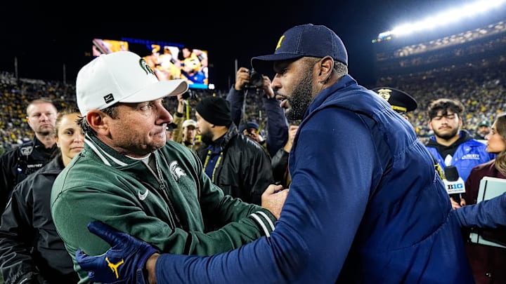 Michigan State head coach Jonathan Smith, left, shakes hands with head coach Sherrone Moore after 24-17 loss at Michigan Stadium in Ann Arbor on Saturday, Oct. 26, 2024.