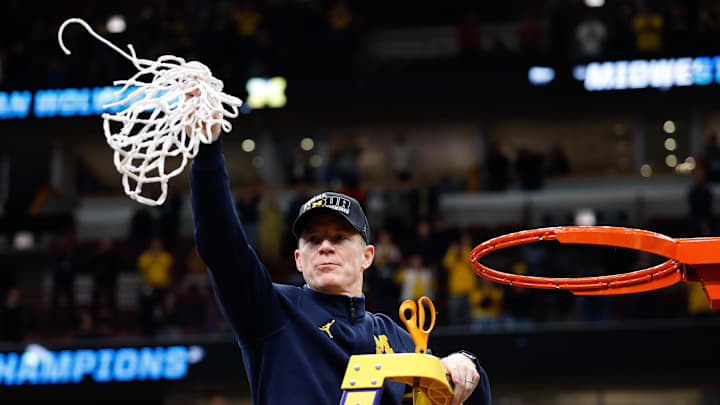 Mar 29, 2026; Chicago, IL, USA; Michigan Wolverines head coach Dusty May cuts the net after defeating the Tennessee Volunteers in an Elite Eight game of the Midwest Regional of the men's 2026 NCAA Tournament at United Center. Mandatory Credit: Kamil Krzaczynski-Imagn Images