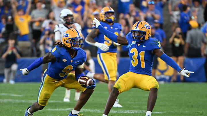 Sep 14, 2024; Pittsburgh, Pennsylvania, USA; Pittsburgh Panthers linebacker Kyle Louis celebrates with linebacker Rasheem Biles (31) after intercepting West Virginia Mountaineers quarterback Garrett Greene (6) in the fourth quarter at Acrisure Stadium. Mandatory Credit: Barry Reeger-Image Images