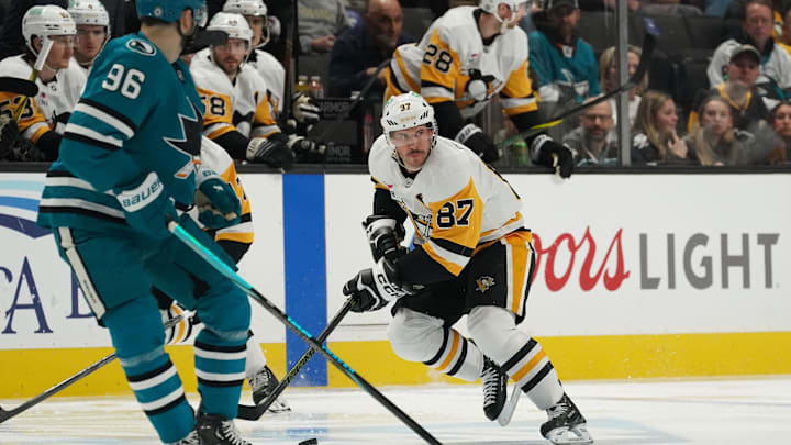 Jan 27, 2025; San Jose, California, USA; Pittsburgh Penguins center Sidney Crosby (87) advances the puck toward San Jose Sharks defenseman Jake Walman (96) during the first period at SAP Center at San Jose. Mandatory Credit: David Gonzales-Imagn Images