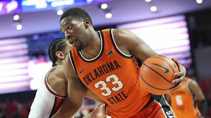 Feb 4, 2025; Houston, Texas, USA; Oklahoma State Cowboys forward Abou Ousmane (33) controls the ball during the second half against the Houston Cougars at Fertitta Center. Mandatory Credit: Troy Taormina-Imagn Images