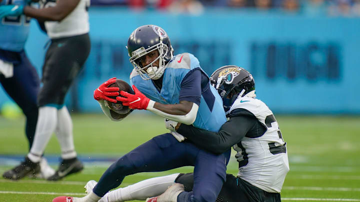 Tennessee Titans wide receiver Calvin Ridley (0) is stopped by Jacksonville Jaguars cornerback Montaric Brown (30) after a gain of four yards during the third quarter at Nissan Stadium in Nashville, Tenn., Sunday, Dec. 8, 2024.
