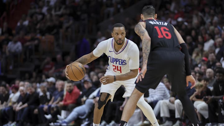 Feb 4, 2024; Miami, Florida, USA; LA Clippers guard Norman Powell (24) dribbles the basketball as Miami Heat forward Caleb Martin (16) defends during the fourth quarter at Kaseya Center. Mandatory Credit: Sam Navarro-Imagn Images