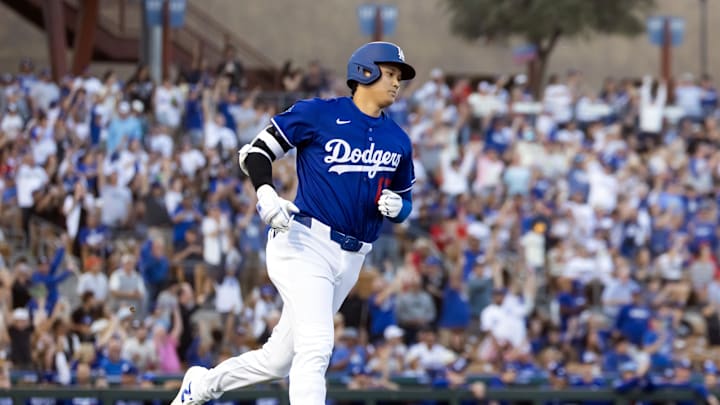 Feb 28, 2025; Phoenix, Arizona, USA; Los Angeles Dodgers designated hitter Shohei Ohtani (17) rounds the bases after hitting a leadoff home run against the Los Angeles Angels during a spring training game at Camelback Ranch-Glendale. Mandatory Credit: Mark J. Rebilas-Imagn Images