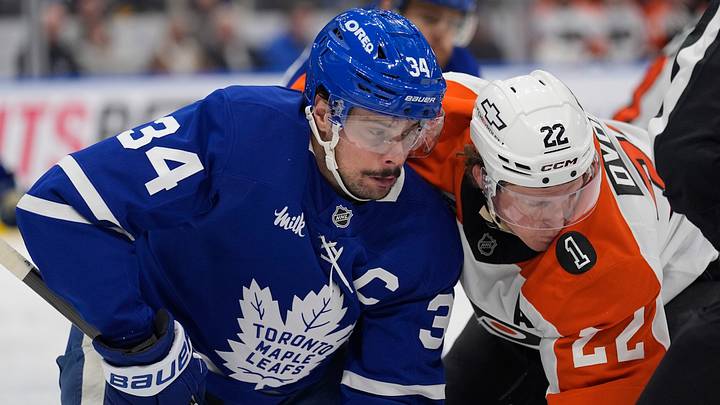 Mar 2, 2026; Toronto, Ontario, CAN; Toronto Maple Leafs forward Auston Matthews (34) and Philadelphia Flyers forward Christian Dvorak (22) battle for position after a face off during the second period at Scotiabank Arena. Mandatory Credit: John E. Sokolowski-Imagn Images