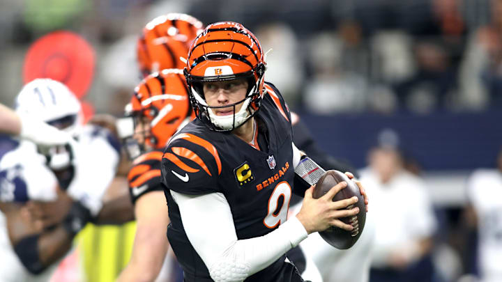 Dec 9, 2024; Arlington, Texas, USA; Cincinnati Bengals quarterback Joe Burrow (9) rolls out to pass against the Dallas Cowboys in the first quarter at AT&T Stadium. Mandatory Credit: Tim Heitman-Imagn Images