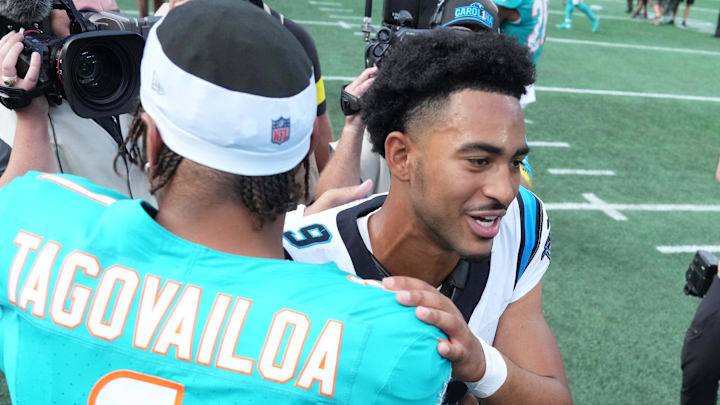 Carolina Panthers quarterback Bryce Young (9) with Miami Dolphins quarterback Tua Tagovailoa (1) after the game